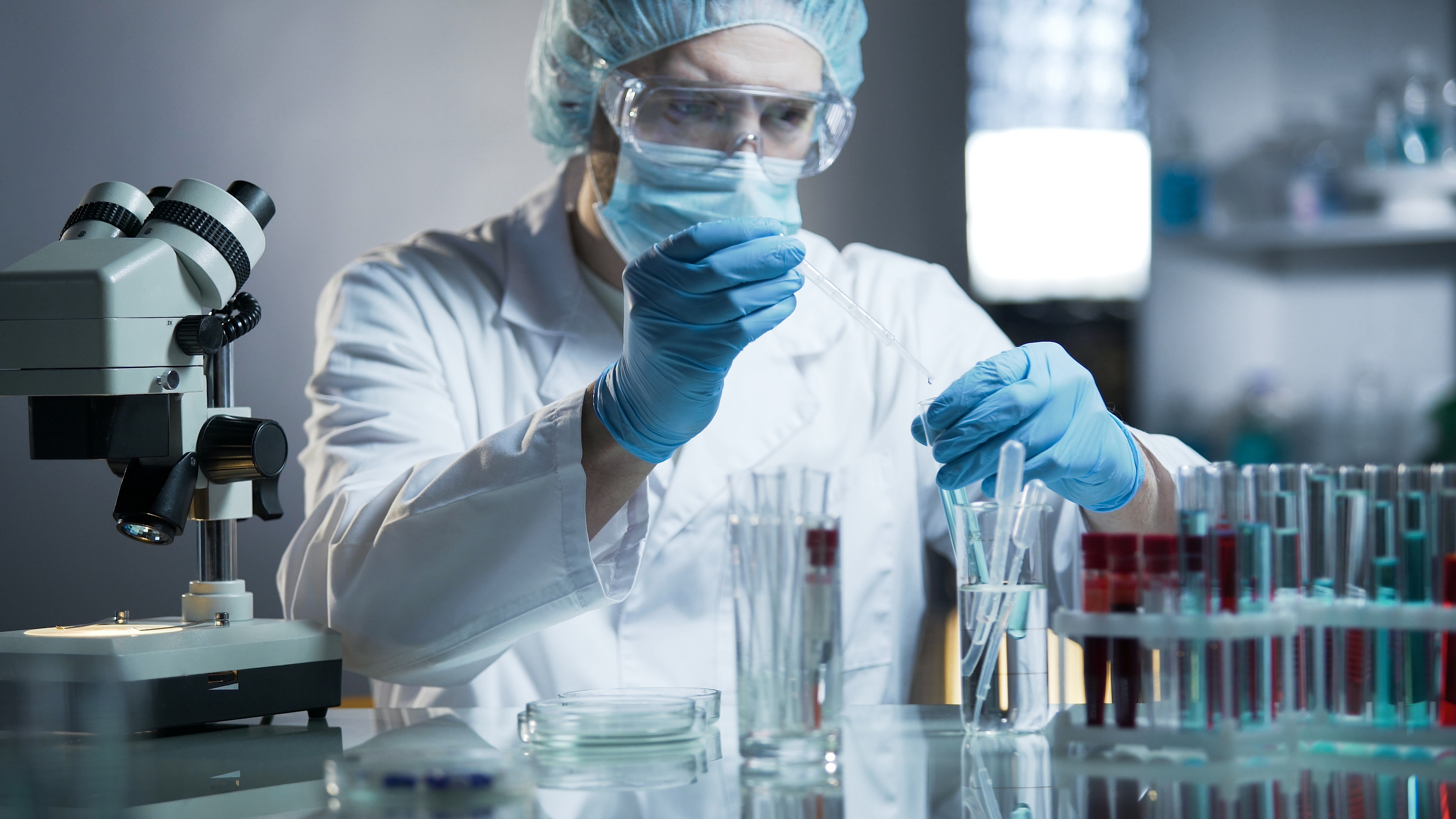 Scientist working in a lab dripping specimens into test tube